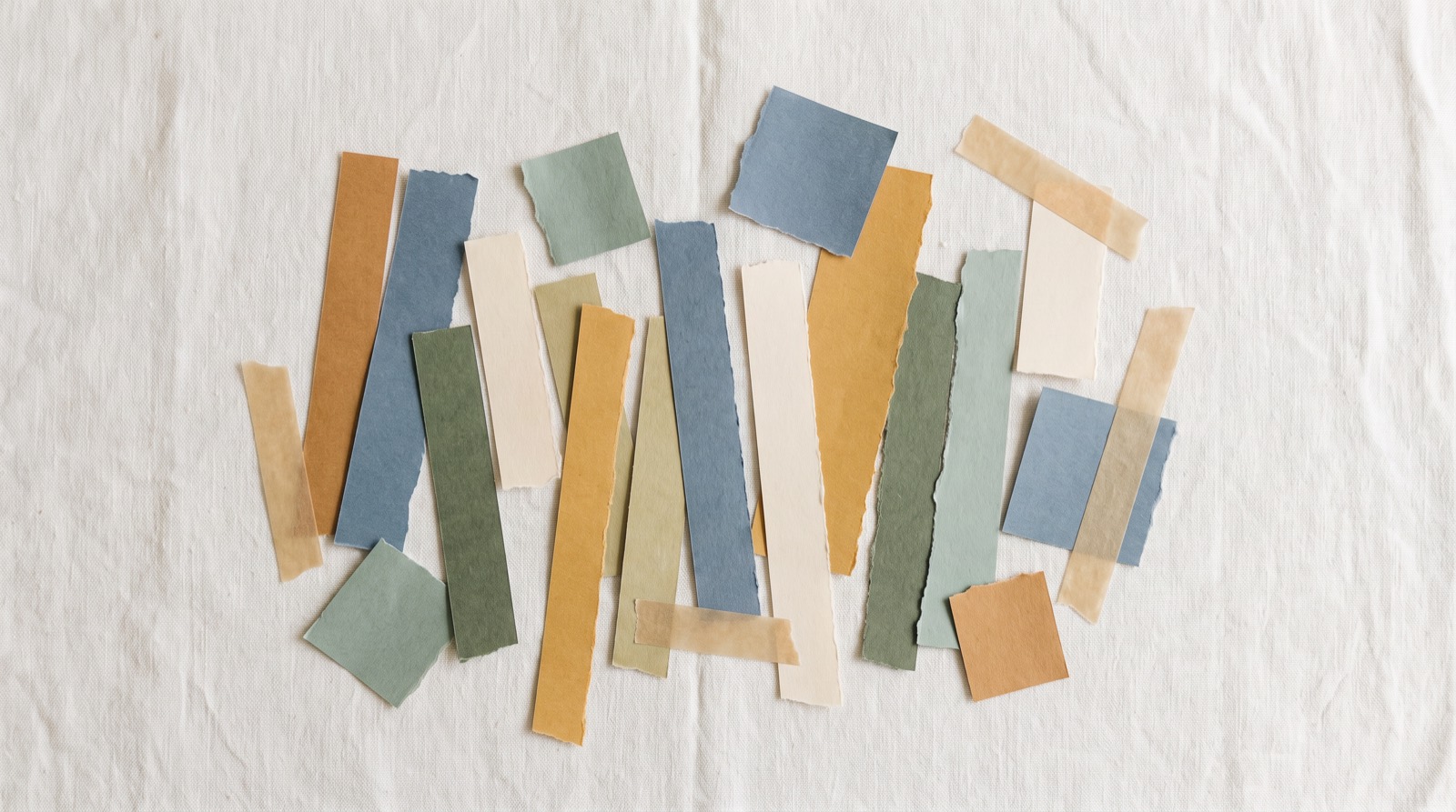 Torn strips of coloured paper and tape